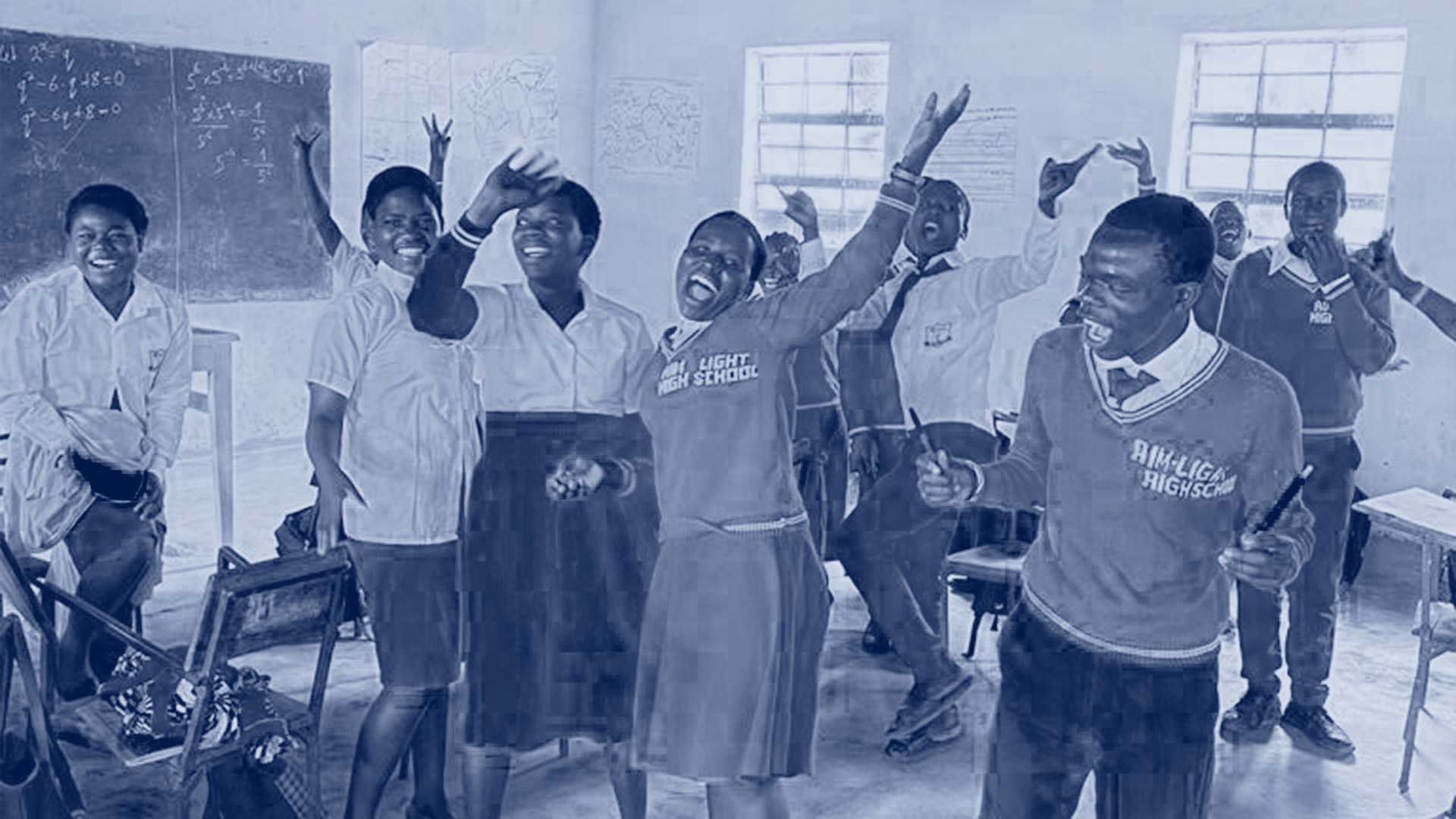 high-school students celebrating/dancing in a classroom